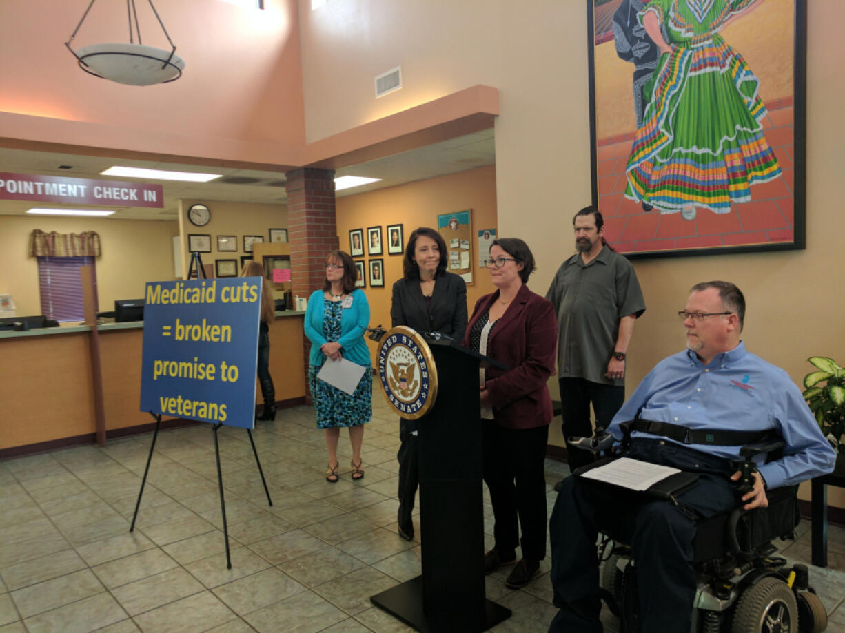 From left, SeaMar clinic manager Hope Murray and U.S. Sen. Maria Cantwell listen as Emily Cooper of Disability Rights Washington, center, talks about the American Health Care Act during a press conference Saturday at SeaMar in Vancouver. Veterans R.C. Wells and Mike Rosenbalm, right, later said that if the House-approved bill became law many veterans would suffer.