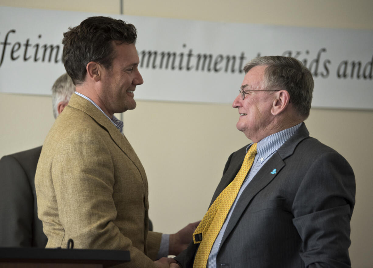 Vancouver mayor Tim Leavitt, left, thanks Evergreen Superintendent John Deeder during Deeder’s retirement celebration at HeLa High School in Vancouver earlier this month.