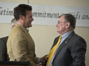 Vancouver mayor Tim Leavitt, left, thanks Evergreen Superintendent John Deeder during Deeder’s retirement celebration at HeLa High School in Vancouver earlier this month.