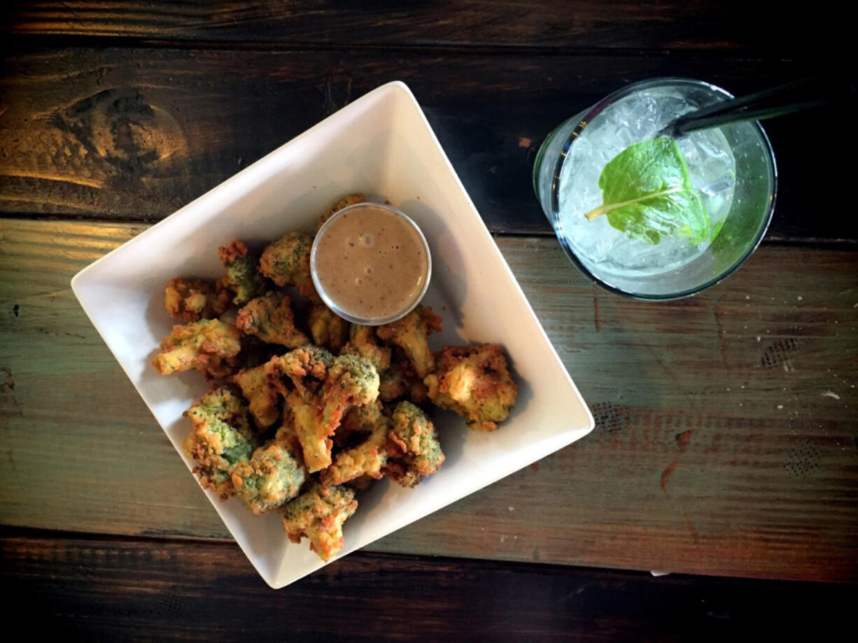 Pacific House serves a deep-fried broccoli dish with a black garlic dipping sauce, which pairs with nicely with a tangy, minty Northwest Fizz.