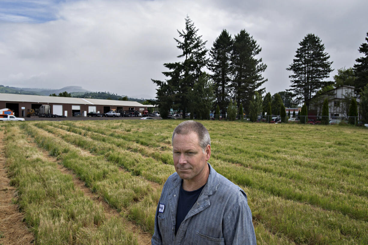 Doug Fredrickson, owner of A-1 Truck Repair, in an empty lot across the street from his business. City officials are looking into rezoning the lot from light industrial to residential so developers who purchased the land can build a 76-unit luxury apartment complex, something Fredrickson and other nearby business owners don't want to see happen.