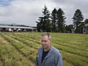 Doug Fredrickson, owner of A-1 Truck Repair, in an empty lot across the street from his business. City officials are looking into rezoning the lot from light industrial to residential so developers who purchased the land can build a 76-unit luxury apartment complex, something Fredrickson and other nearby business owners don't want to see happen.