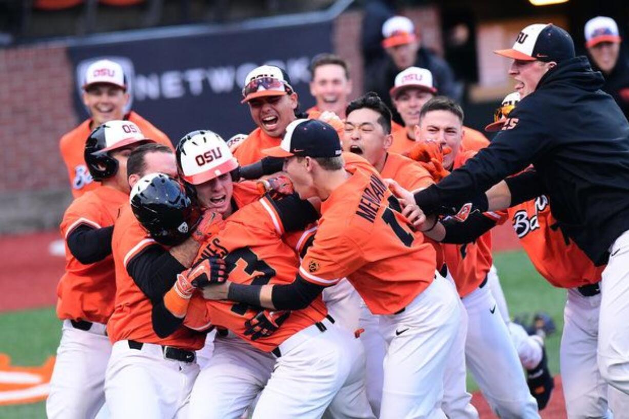 Oregon State celebrates after Preston Jones scored from second base on a wild pitch in the ninth inning to give the Beavers a 5-4 win over Arizona on March 25.