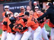 Oregon State celebrates after Preston Jones scored from second base on a wild pitch in the ninth inning to give the Beavers a 5-4 win over Arizona on March 25.