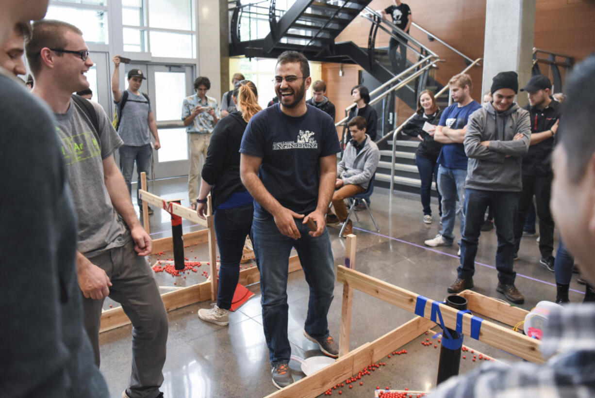 Kinan Badr, center, laughs with other engineering students during an engineering club competition Friday in Clark College’s STEM Building. Badr emigrated from Syria when he was 16 and now, at age 24, is graduating from Clark College. He won a student award for his work with the engineering program.