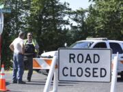 Clark County sheriff’s deputies direct traffic away from Northeast 182nd Avenue at Fourth Plain Road after a bank robbery suspect was shot and killed after he traded gunfire with police. The man allegedly robbed the iQ Credit Union at 15705 N.E. Fourth Plain Blvd. No officers were injured.