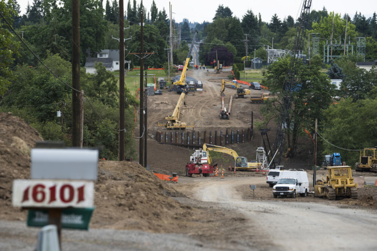 Workers continue construction of the new bridge and roadway connecting Northeast 10th Avenue over Whipple Creek just south of the Clark County Fairgrounds on Monday morning.