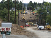 Workers continue construction of the new bridge and roadway connecting Northeast 10th Avenue over Whipple Creek just south of the Clark County Fairgrounds on Monday morning.