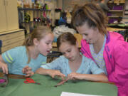 Washougal: Gause Elementary School third-graders, from left, Gracie Hack, Avery Morgan and Adyson Greenberg dissect a fish during a lesson with representatives from the Lower Columbia Estuary Partnership.