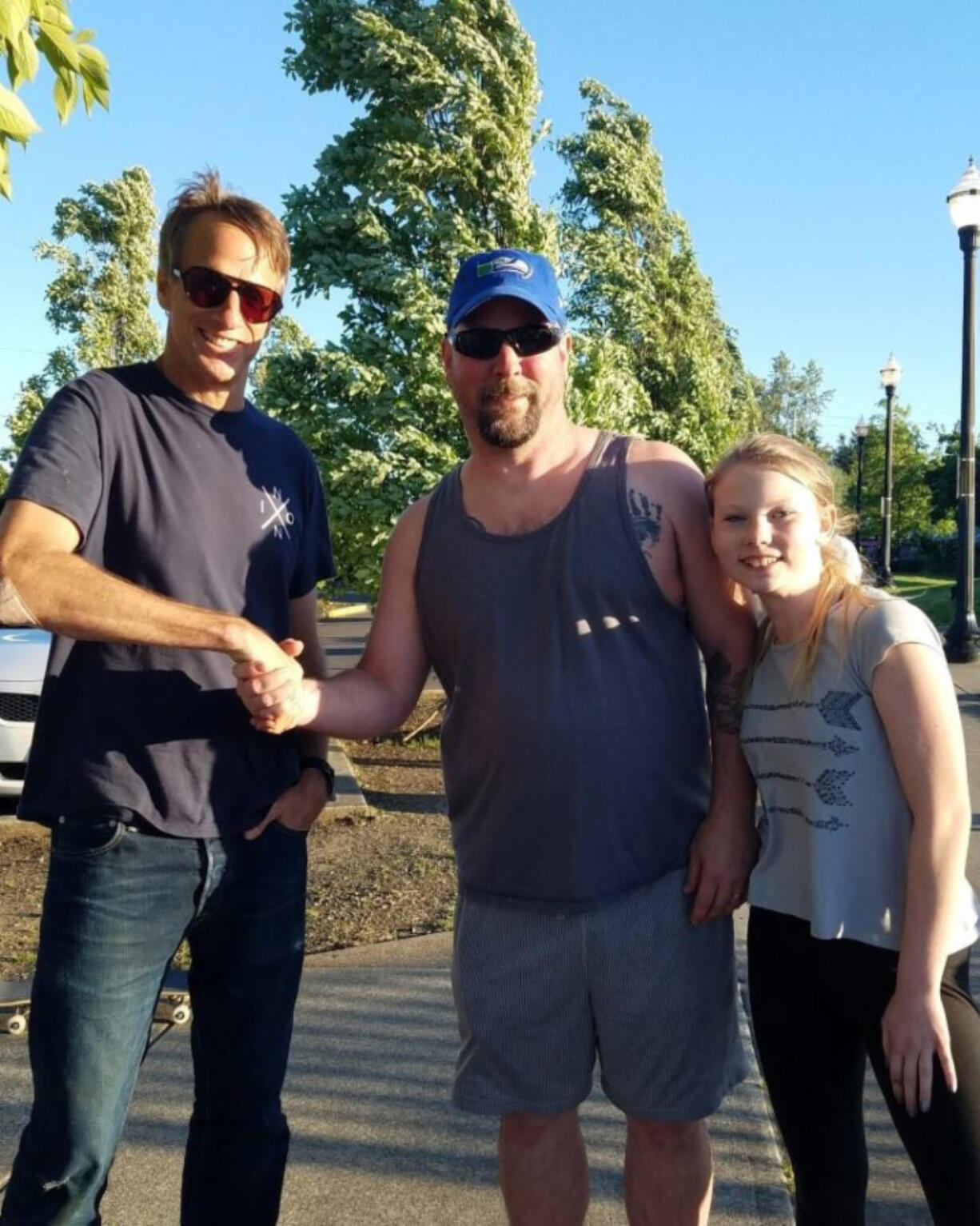 Battle Ground: Legendary pro skater Tony Hawk, left, stopped by the Battle Ground Skate Park last month to film a movie segment, and was welcomed to the area by City Councilor Brian Munson and his daughter Ashlyn Munson.