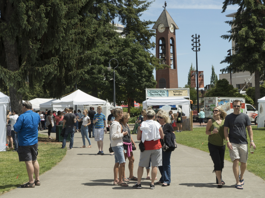 The crowd walks through Esther Short Park in downtown Vancouver during last the 2017 Craft Beer and Wine Fest.