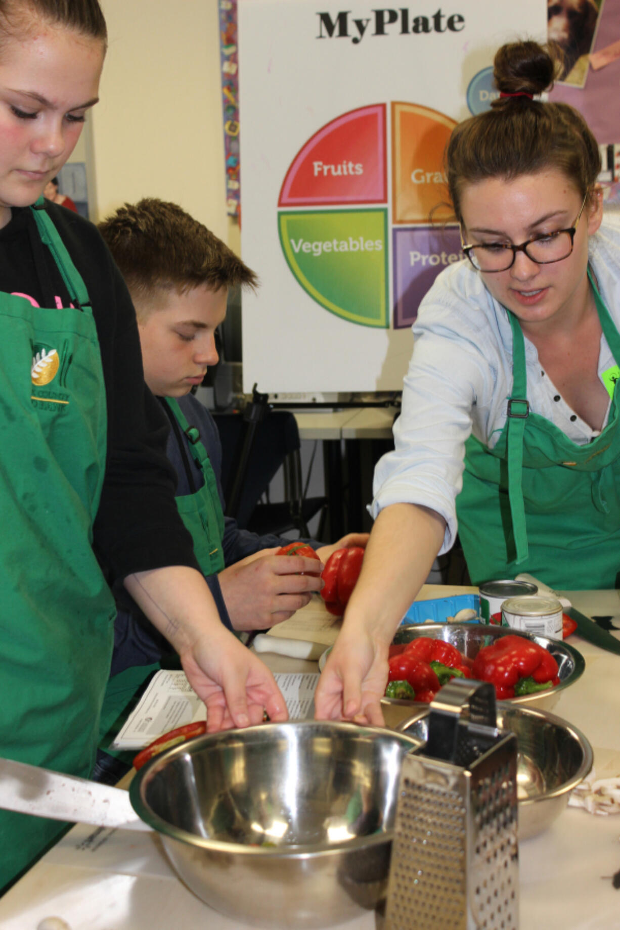 Fisher-Mill Plain: Allie Bryant, AmeriCorps nutrition educator, leads a Cooking Matters class. This year, Evergreen Public Schools joined with the Clark County Food Bank and Student Nutrition and Cooking to offer the free six-week course where students learned about healthy cooking and eating.