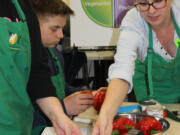 Fisher-Mill Plain: Allie Bryant, AmeriCorps nutrition educator, leads a Cooking Matters class. This year, Evergreen Public Schools joined with the Clark County Food Bank and Student Nutrition and Cooking to offer the free six-week course where students learned about healthy cooking and eating.