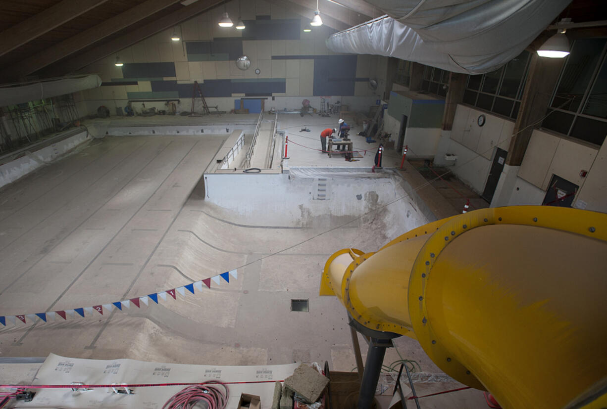 Brandon Duston, left, and Burt Rask of Pease Construction lend a hand during renovation work at the Marshall Community Center pool Friday morning. Unexpected extra work will delay the reopening to approximately mid-August.