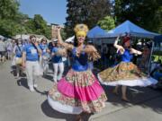 Deborah Galvan, center, and the MARACATUpdx Brazilian marching band leads the Processions of the Species parade at the Recycled Arts Festival in Esther Short Park on Sunday.