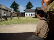 Fort Vancouver National Historic Site Park Ranger Mike Twist fires a Hudson’s Bay Trade musket during “Survive and Thrive,” a survival skills training pilot program taught at Fort Vancouver on Saturday. Participants were taught hands-on survival skills in a mid-19th century context.