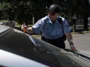 Vancouver police service technician Julie Cleveland tags an abandoned vehicle in northeast Vancouver. The Vancouver Police Department recently put police service technicians on patrol to respond to low-level calls in the field.