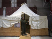 Bob Cromwell, manager of Pearson Air Museum, looks over a tent that was built to century-old specs by the company that made the original spruce mill tents for Vancouver Barracks during World War I.