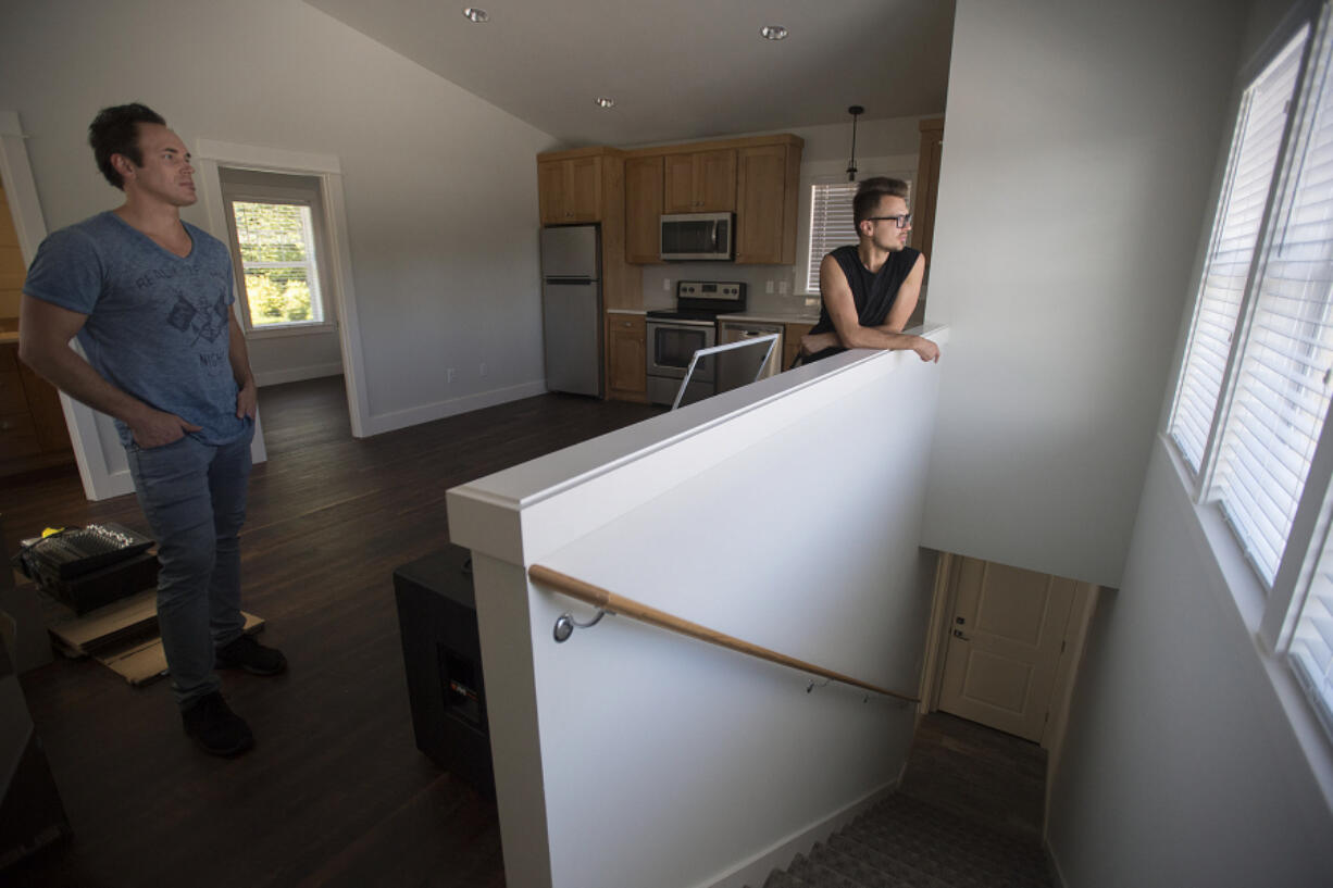 Vancouver resident Dmitriy Manzhura, left, and friend Boris Prikhodko on Tuesday look over an accessory dwelling unit that they built in Vancouver’s Carter Park neighborhood.