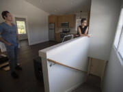 Vancouver resident Dmitriy Manzhura, left, and friend Boris Prikhodko on Tuesday look over an accessory dwelling unit that they built in Vancouver’s Carter Park neighborhood.