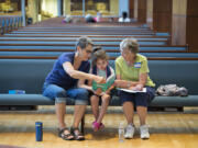 Volunteer Karen Beilsmith of Salmon Creek United Methodist Church, from left, reads to Mila Hughes, 6, with fellow volunteer and church member Karen West during Project Transformation at Vancouver First United Methodist Church on Thursday morning. The new summer day camp is designed to ease the summer learning loss children suffer over the summer away from school.