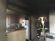 Firefighters inspect the damage after a kitchen fire in the Harney Heights neighborhood Monday evening. No one was hurt in the fire.