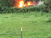 The view from Northwest Pacific Highway as firefighters with Clark County Fire & Rescue arrived to a large blaze Thursday night that destroyed three travel trailers near La Center.