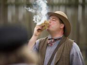 Mike Twist, National Park Service ranger, shows how to make fire with flint and steel and a handful of tinder during a living history program at Fort Vancouver National Historic Site.