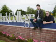 Clark College students, Brady Johnson, left, and Brady’s father, Kelly Johnson, are pictured with the Clark College sign. Kelly Johnson returned to school after being away for 27 years. Both father and son are in the supervisory management program at Clark.