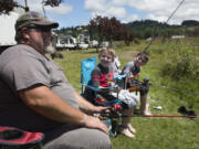 Victor Moore and his twin sons Wyatt and Brody, both 8, fish Horseshoe Lake in Woodland to celebrate Father’s Day Sunday. After fishing, the plan was to check out the carnival set up for Woodland Planters Days, which was also that weekend.