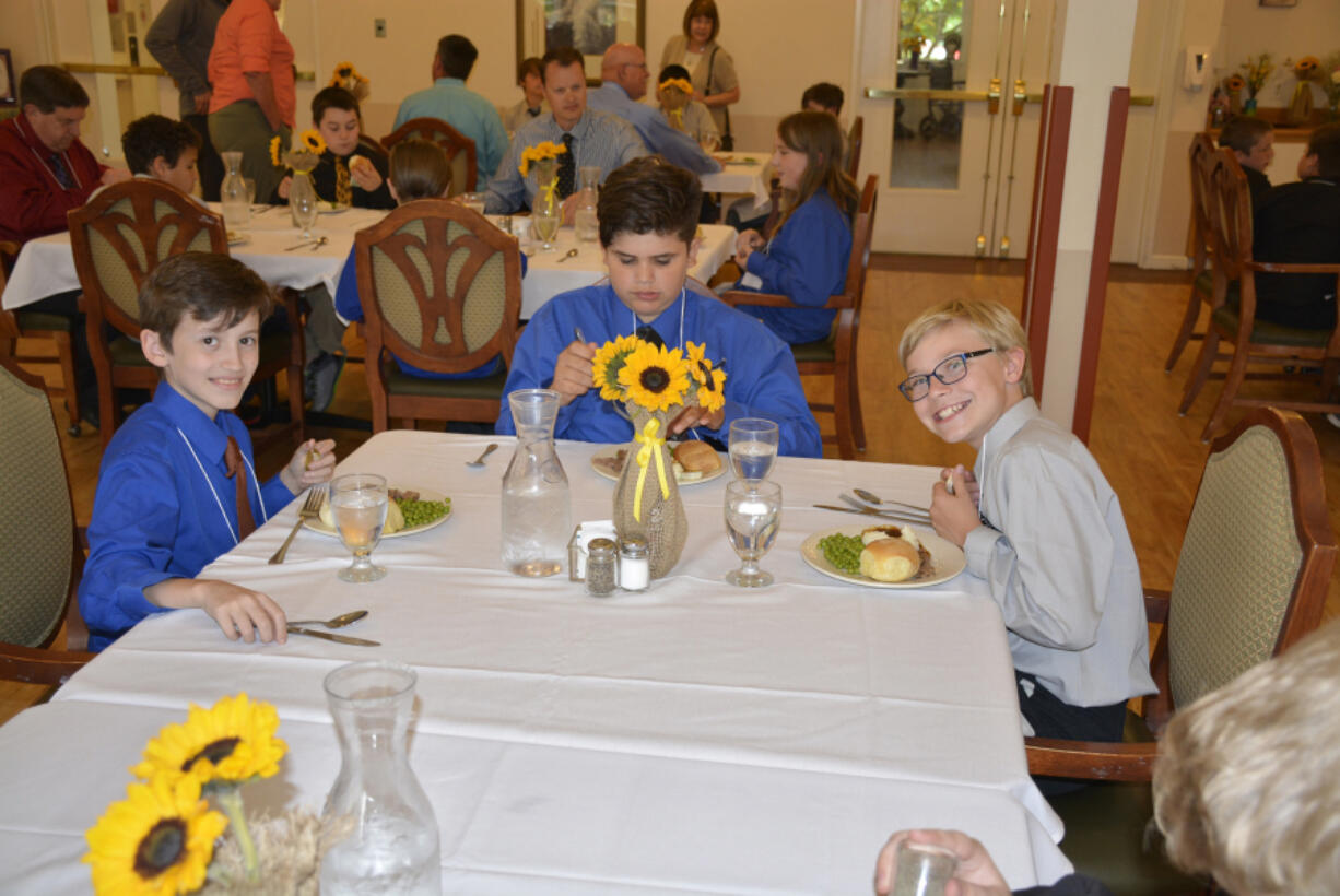 Washougal: Hathaway Elementary School fifth-graders, from left, Evan Schipull, Jose Alvarez-Cruze and Gavin Dowell at the Young Men in Action program, where Camas-Washougal Rotary Club members mentor the students and teach them various life skills.