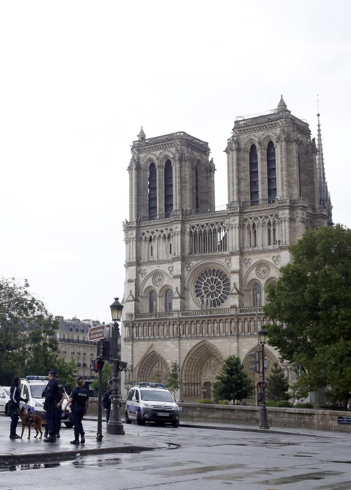 Police officers seal off the access to Notre Dame cathedral in Paris, France, Tuesday, June 6, 2017. Paris police say an unidentified assailant has attacked a police officer near the Notre Dame Cathedral, and the officer then shot and wounded the attacker.