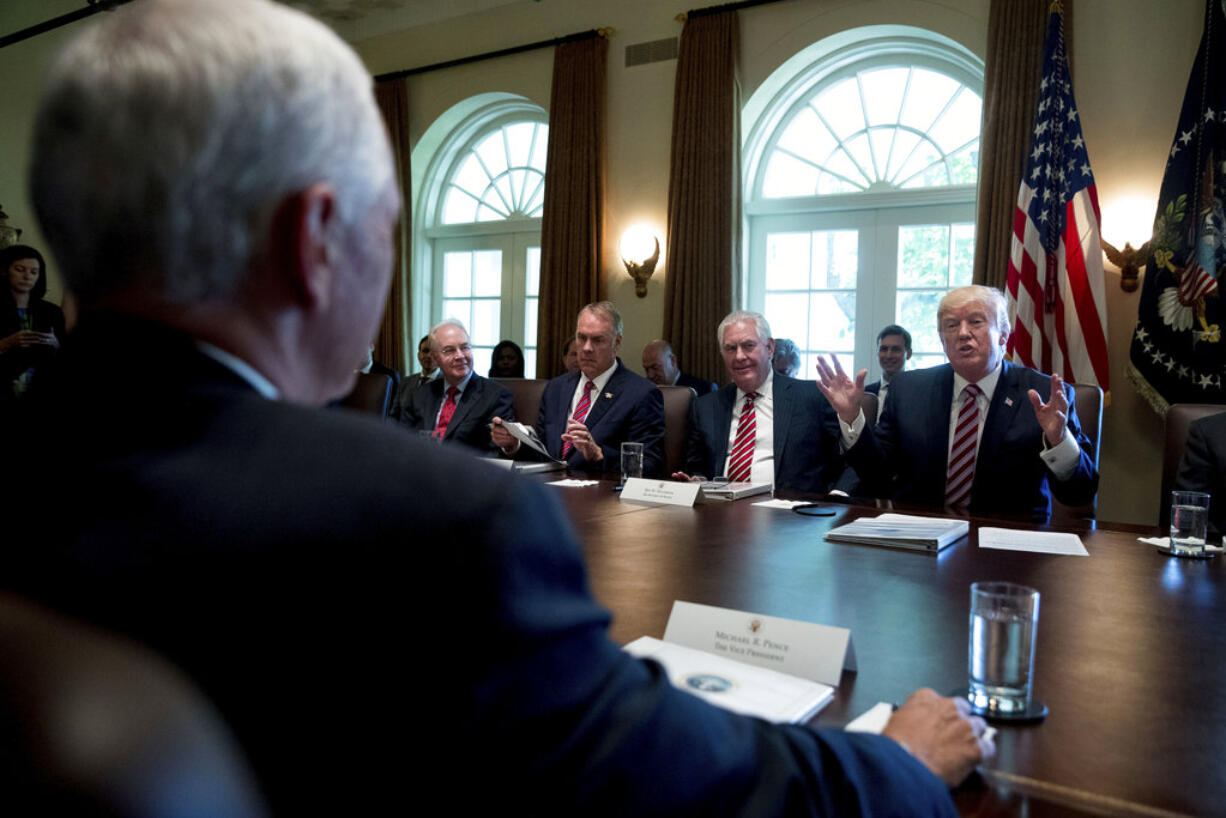 President Donald Trump speaks during a Cabinet Meet, Monday, June 12, 2017, in the Cabinet Room of the White House in Washington. From left are, Vice President Mike Pence, foreground, Health and Human Services Secretary Tom Price, Interior Secretary Ryan Zinke and Secretary of State Rex Tillerson and the president .