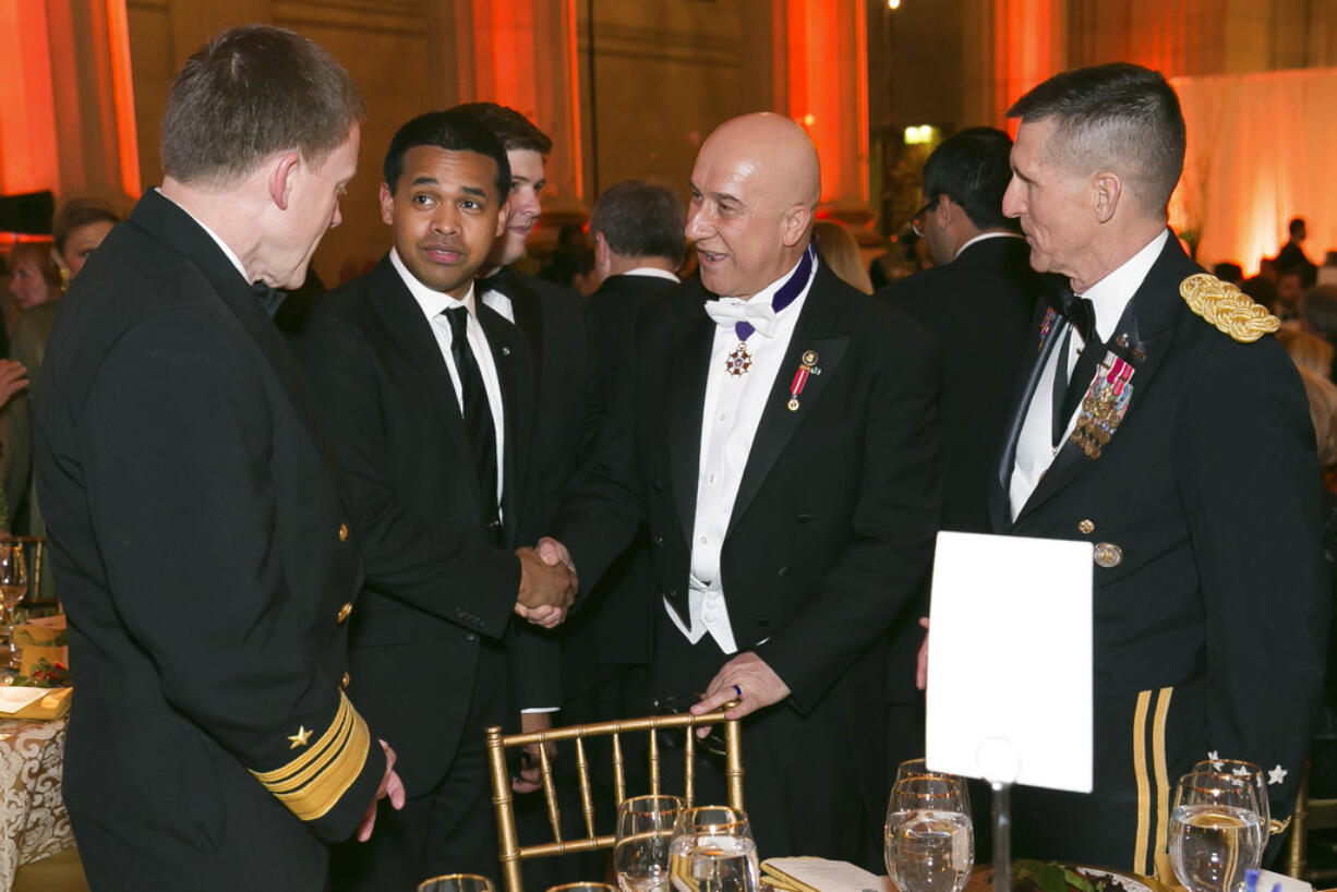 In this March 15, 2014, photo provided by Alfredo Flores, from left, Vice Admiral Michael Rogers; Paul Monteiro, vice chairman and co-Founder of Nowruz Commission; Bijan R. Kian and Lt. Gen. Michael Flynn talk during the Fifth Annual Nowruz Commission Gala at the Andrew W. Mellon Auditorium in Washington. As Michael Flynn spent last fall campaigning as Donald Trump’s top national security adviser, Bijan Kian, his little-known business partner supervised much of the foreign political work for Turkish interests that has boomeranged back on Flynn, now the target of a federal criminal investigation and congressional inquiries.