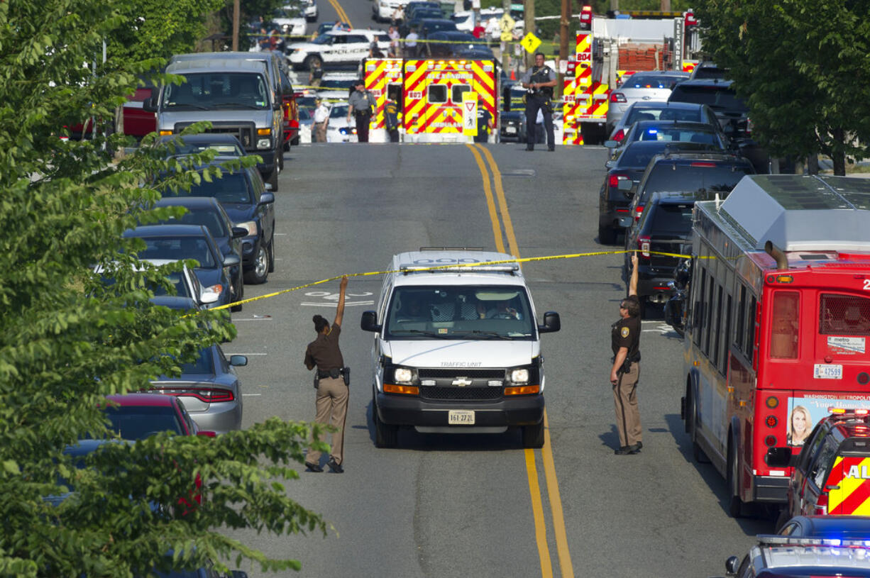 Police and emergency personnel are seen near the scene where House Majority Whip Steve Scalise of La. was shot during a Congressional baseball practice in Alexandria, Va., Wednesday, June 14, 2017.