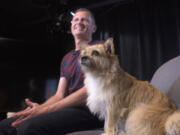 In this Wednesday, June 14, 2017 photo, Dion Leonard and his dog, Gobi, prepare for an interview in New York. During a 155-mile race across the Gobi Desert, the dog sought out the the ultra-runner, who seems genuinely baffled by it all. He marvels at Gobi's ease crossing the Tian Shan mountain range and the distance she covered fending mostly for herself for food and water.