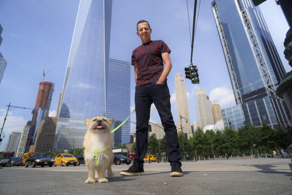 In this Wednesday, June 14, 2017 photo, Dion Leonard and his dog, Gobi, pose for a photo in New York. During a 155-mile race across the Gobi Desert, the dog sought out the the ultra-runner, who seems genuinely baffled by it all. He marvels at Gobi's ease crossing the Tian Shan mountain range and the distance she covered fending mostly for herself for food and water.