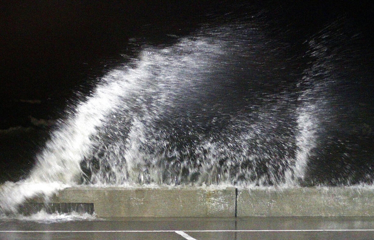 Waves crash into the seawall at the small craft harbor at Jones Park, in Gulfport, Miss., after midnight, Wednesday, June 21, 2017. High tide and rain from feeder bands from Tropical Storm Cindy moved through the coast.