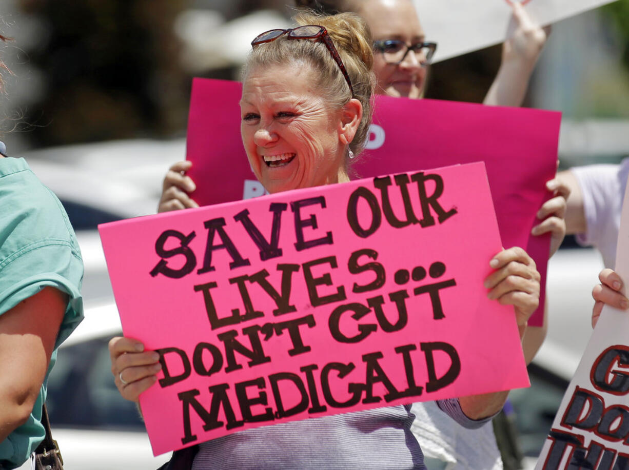 Protesters block a street during a protest against the Republican bill in the U.S. Senate to replace President Barack Obama's health care law Tuesday, June 27, 2017, in Salt Lake City. Demonstrators with Utah's Disabled Rights Action Committee chanted and carried signs while blocking State Street Tuesday afternoon. Utah protesters criticized Utah Republican Sen. Orrin Hatch for supporting the bill and say it will cut life-saving Medicaid services and other health protections.