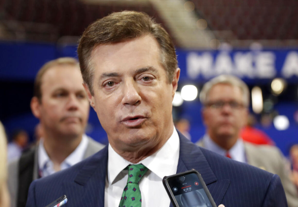 FILE - In this July 17, 2016 file photo, then-Donald Trump campaign chairman Paul Manafort talks to reporters on the floor of the Republican National Convention, in Cleveland. Manafort, President Donald Trump's former campaign chairman, has registered with the Justice Department as a foreign agent for political consulting work he did for a Ukrainian political party, acknowledging he coached party members on how to interact with U.S. government officials.