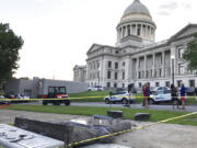 The new Ten Commandments monument outside the state Capitol in Little Rock, Ark., is blocked off Wednesday morning, June 28, 2017, after someone crashed into it with a vehicle, less than 24 hours after the privately funded monument was placed on the Capitol grounds. Authorities arrested a male suspect.