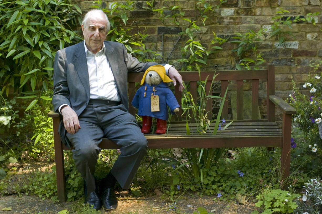 FILE - In this Thursday, June 5, 2008 file photo, British author Michael Bond sits with a Paddington Bear toy during an interview with The Associated Press in London. Publisher HarperCollins says Michael Bond, creator of globe-trotting teddy Paddington bear, died on Tuesday June 27, 2017, aged 91.