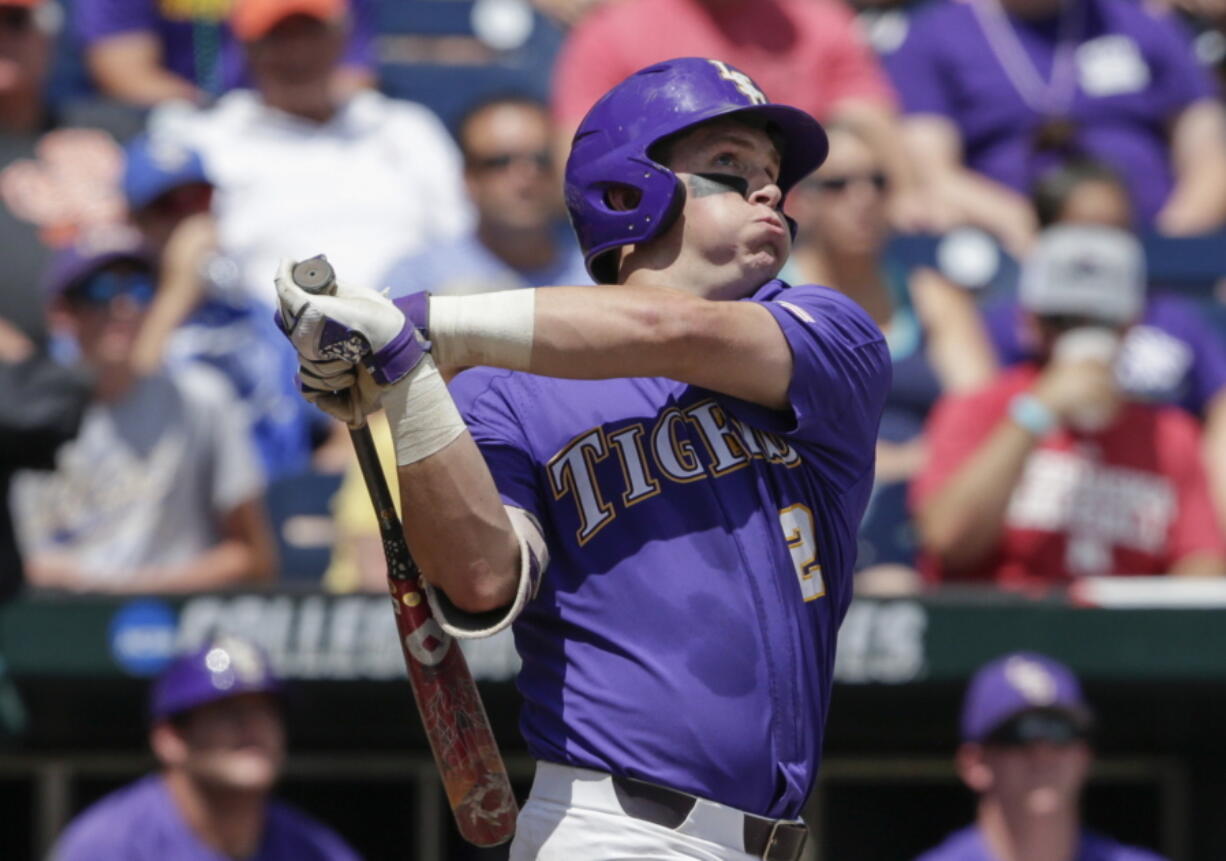 LSU's Michael Papierski (2) follows through on his three-run home run against Oregon State in the third inning of an NCAA College World Series baseball elimination game in Omaha, Neb., Saturday, June 24, 2017.