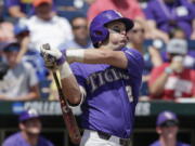 LSU's Michael Papierski (2) follows through on his three-run home run against Oregon State in the third inning of an NCAA College World Series baseball elimination game in Omaha, Neb., Saturday, June 24, 2017.