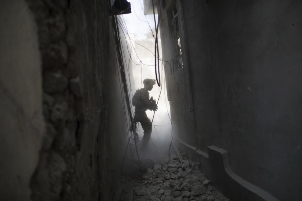 An Iraqi Special Forces soldier exchanges fire with Islamic State militants in the Old City of Mosul, Iraq, Friday, June 30, 2017.