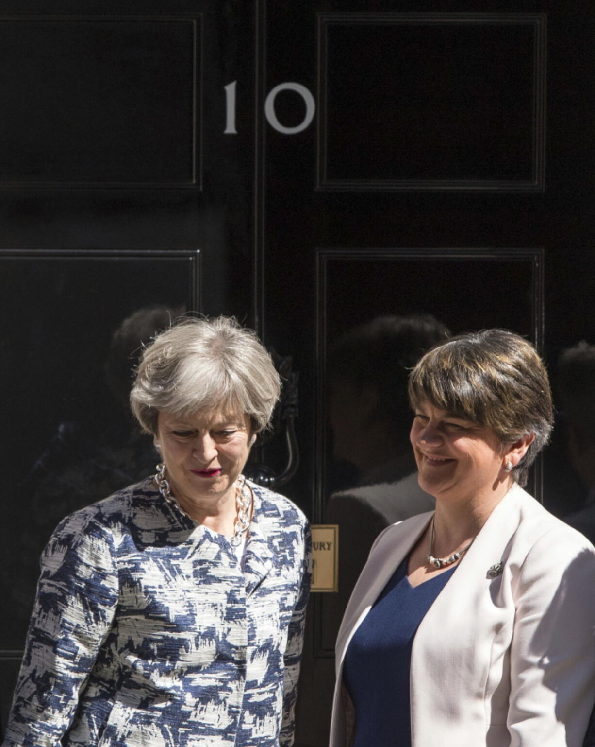 Britain's Prime Minister Theresa May welcomes Democratic Unionist Party (DUP) leader Arlene Foster, right, outside 10 Downing Street in London, Monday June 26, 2017. The leader of a Northern Ireland-based party is in London to finalize an agreement with Prime Minister Theresa May’s Conservative-led government.