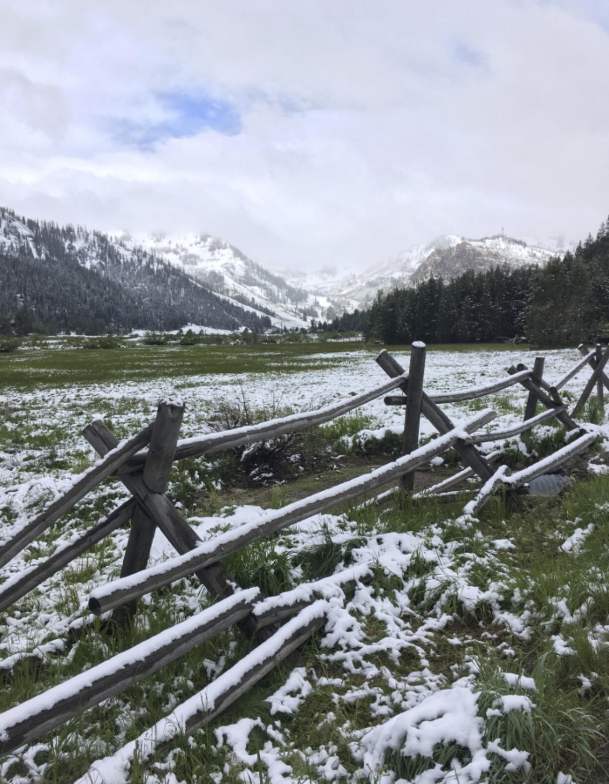 Snow is seen near the Squaw Valley ski resort on Monday in Olympic Valley, Calif. A rare winter-like storm brought more snow to the Sierra Nevada on Monday, giving skiers the opportunity to enjoy the slopes as summer gets underway.