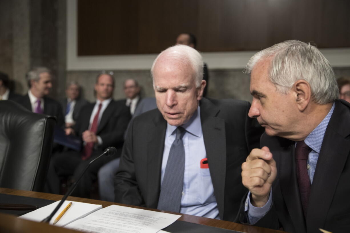 Senate Armed Services Committee Chairman John McCain, R-Ariz., left, confers with Sen. Jack Reed, D-R.I., the ranking member, at the start of a hearing at the Capitol in Washington, Tuesday, June 20, 2017. (AP Photo/J.