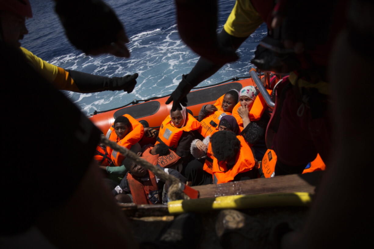 Women and children wait their turn to get on onboard the rescue vessel Golfo Azzurro by members of the Spanish NGO Proactiva Open Arms, after being rescued from a wooden boat sailing out of control in the Mediterranean Sea, about 18 miles north of Sabratha, Libya, on Thursday.