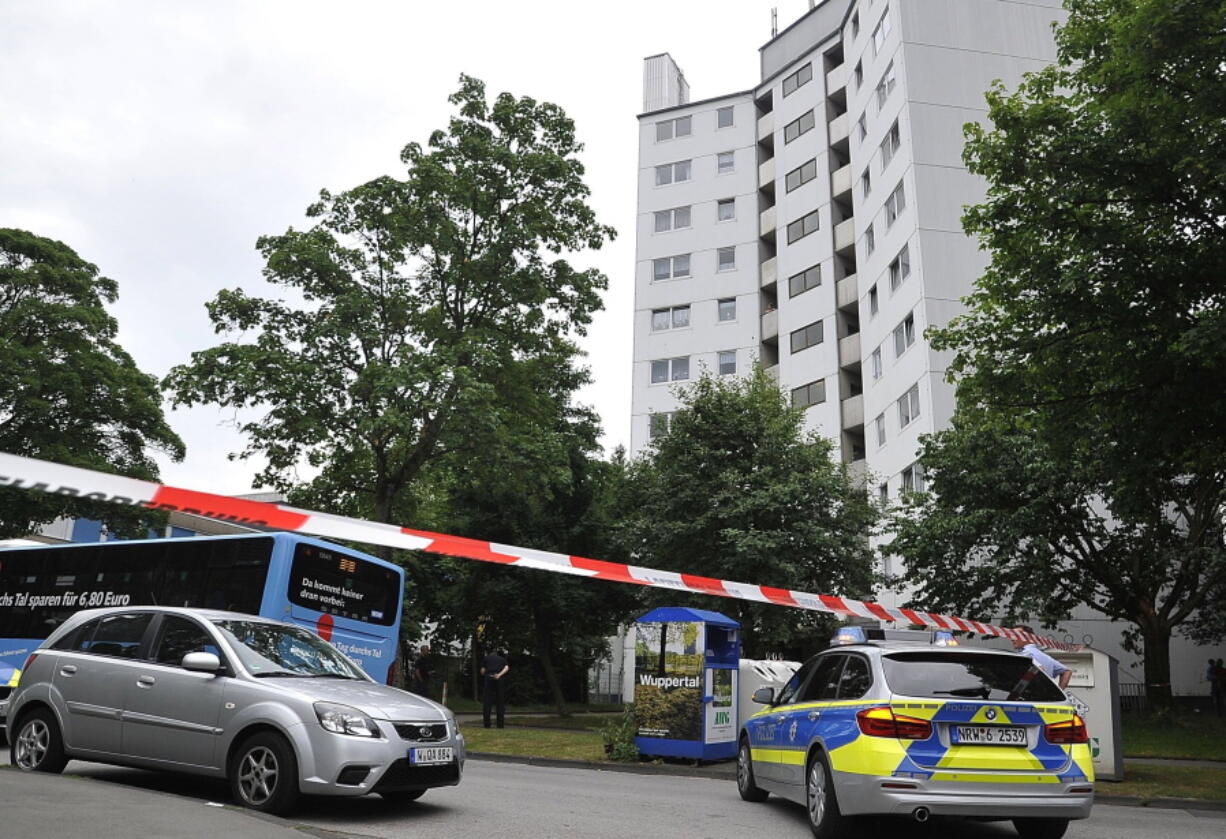 Police stand in front of an apartment block Tuesday in Wuppertal, Germany, that was evacuated because of concerns over exterior insulation similar to that of London’s Grenfell Tower.